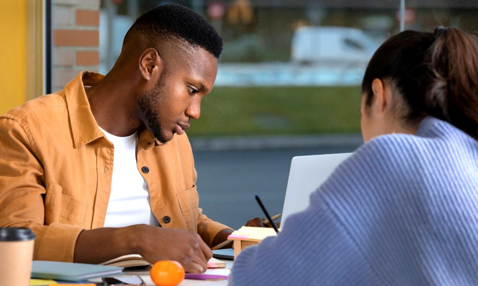Students engaged in interactive financial planning workshop with charts and calculators