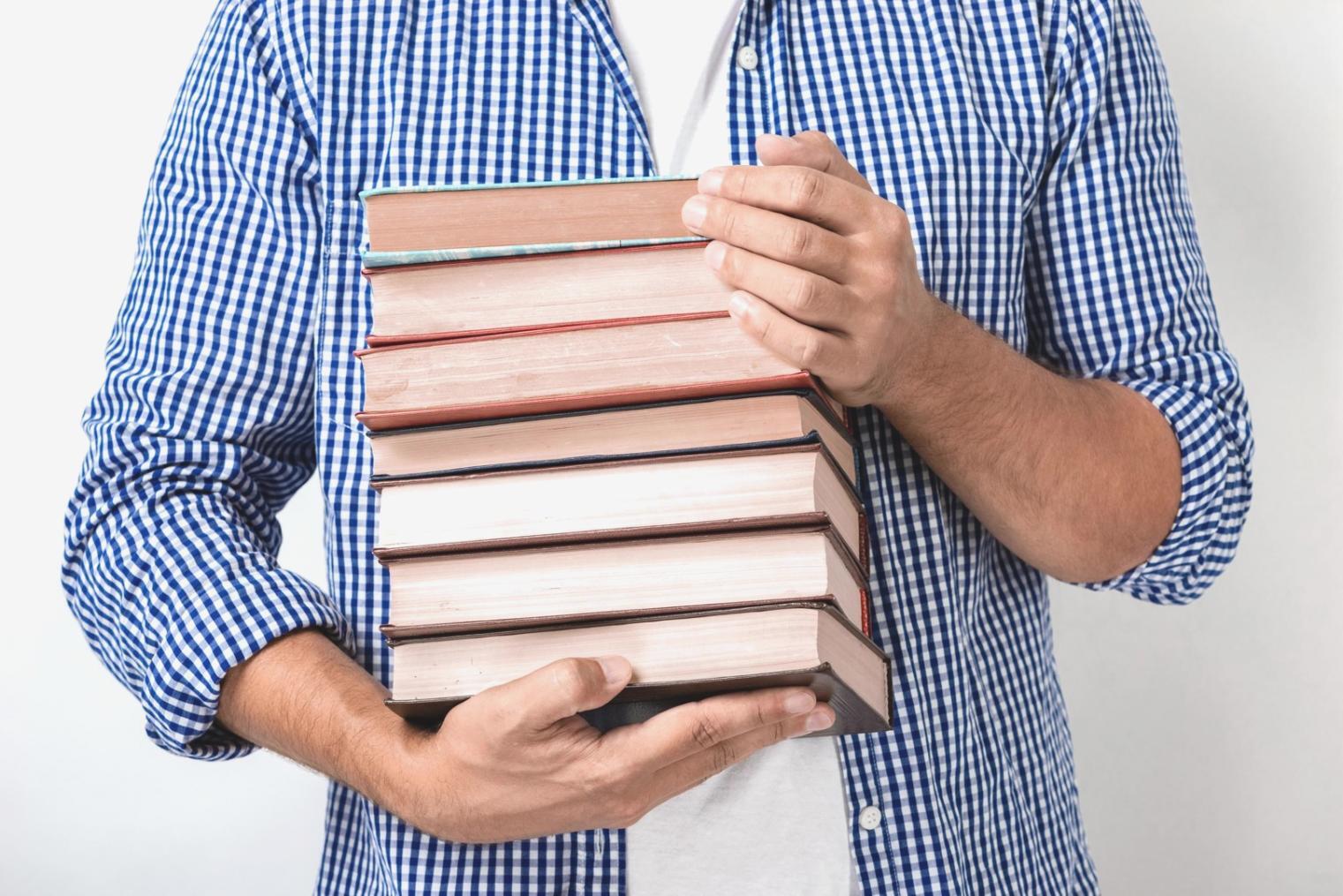 Confident professionals celebrating financial education success with laptops and documents in modern learning environment