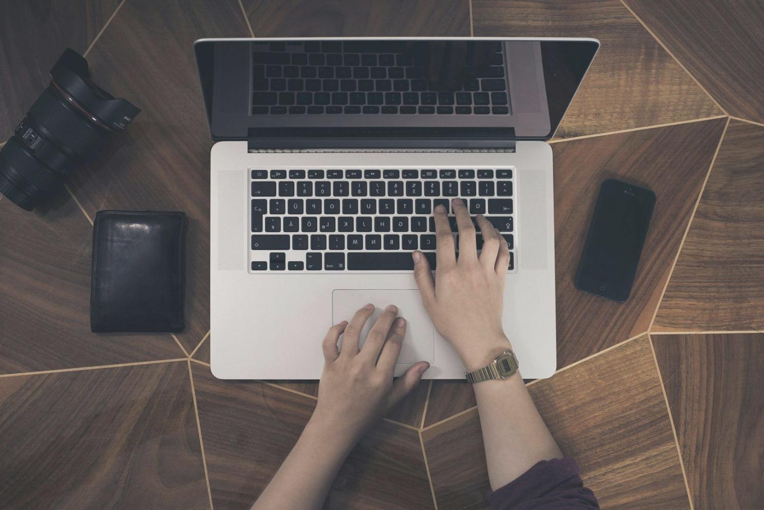 Students engaged in collaborative financial planning workshop with charts and calculators on desk