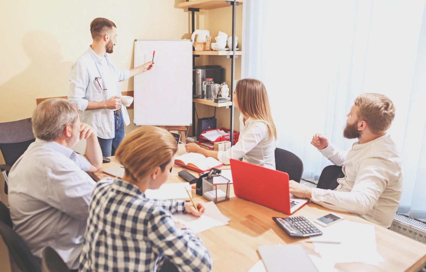 Financial expert reviewing investment charts and market data while providing personalized education guidance